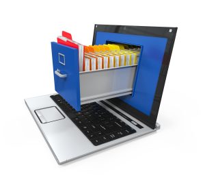 Laptop computer with the screen open and a filing cabinet full of folders extending out indicating that paper documents can be scanned and stored on compter systems making them easily accessible to authorised users no matter where they are.